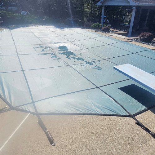 Cleaning pool saftey cover holes.